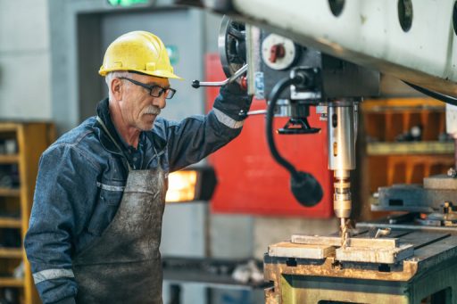 Turner worker working on drill bit in a workshop